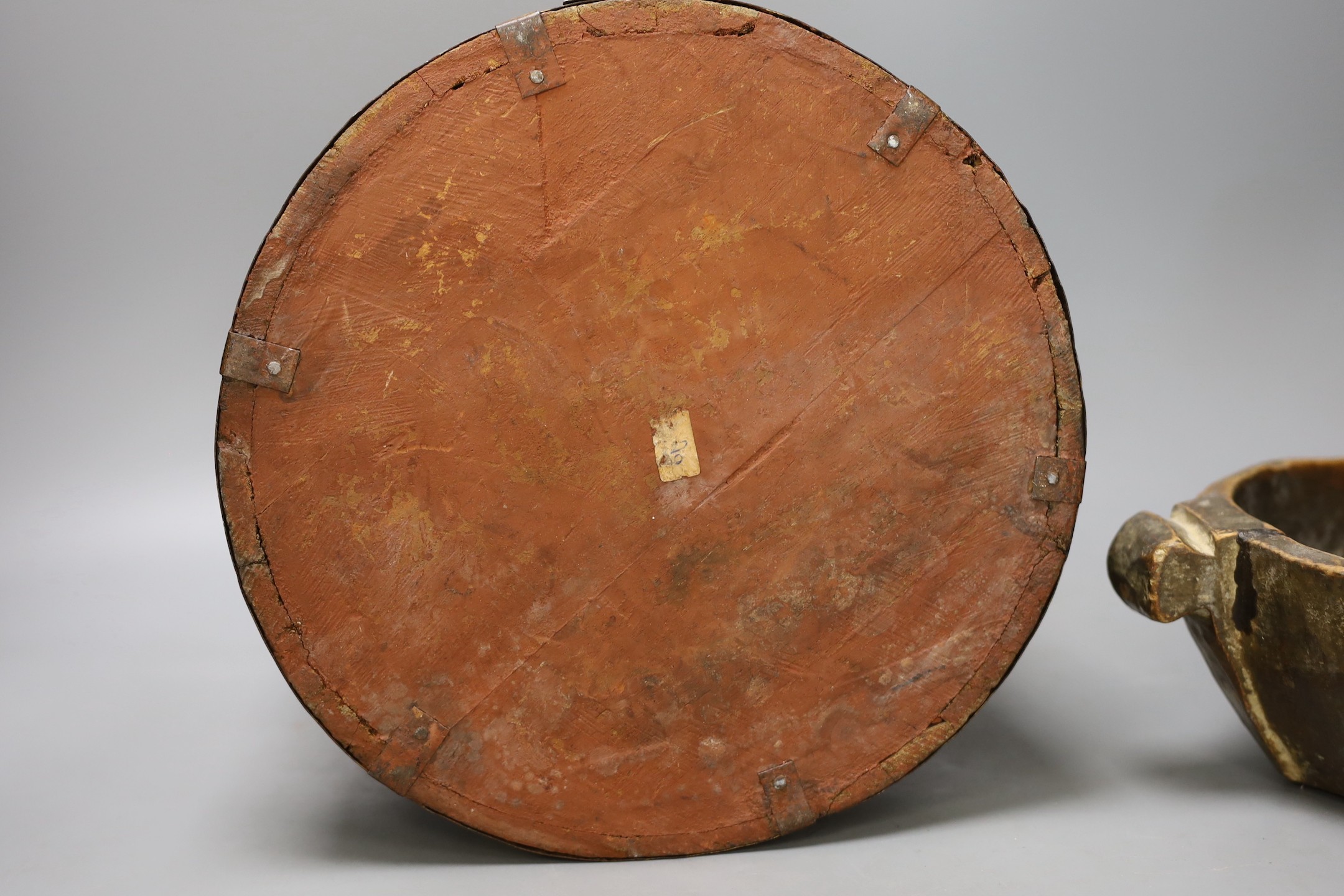 An African carved wood bowl, a Tibetan prayer wheel and a Persian waste basket